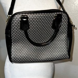 Black purse with white design and gold hardware